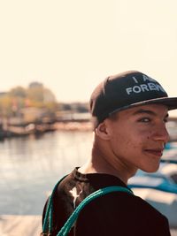 Portrait of young man wearing hat against sky