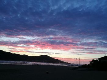 Scenic view of beach against sky during sunset