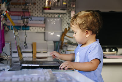 Young child watching videos on a laptop person