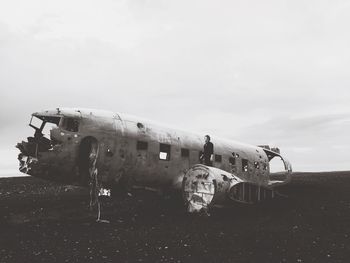 Abandoned airplane against sky