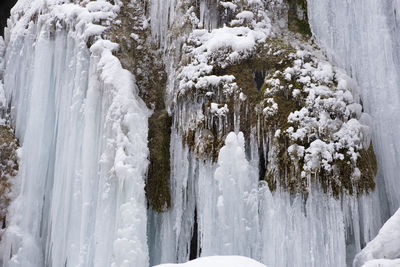 Icicles of stream in cascade over rocks