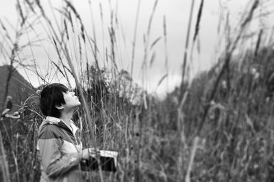 Woman standing on grassy field