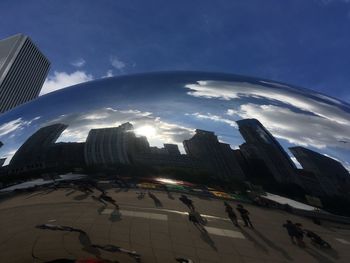 Buildings in city against cloudy sky