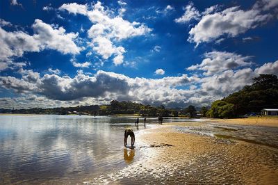 Scenic view of lake against cloudy sky