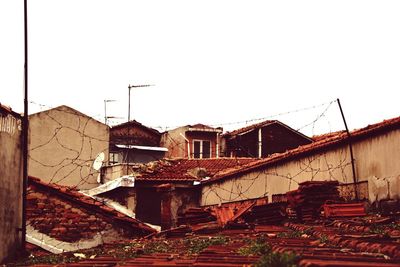 Abandoned houses against clear sky