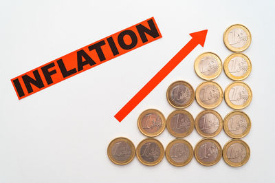 High angle view of coins on white background