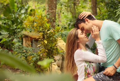 Side view of couple falling in love at public park