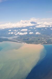 Aerial view of sea and landscape against sky