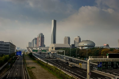 Railroad tracks amidst buildings in city against sky