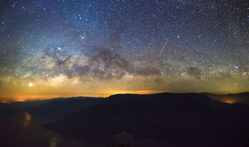 Scenic view of silhouette mountain against sky at night