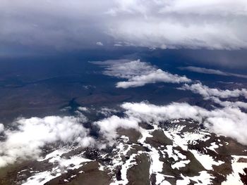 Aerial view of snowcapped mountains against sky