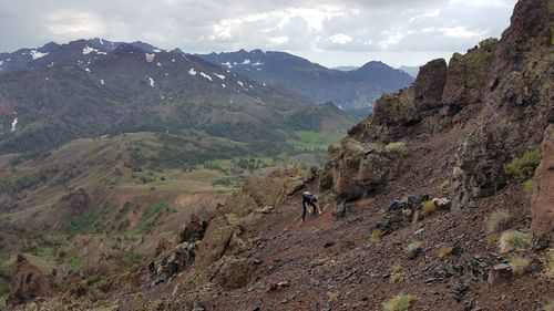 Woman standing on mountain against sky