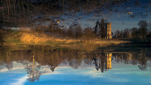 Reflection of trees in lake against sky