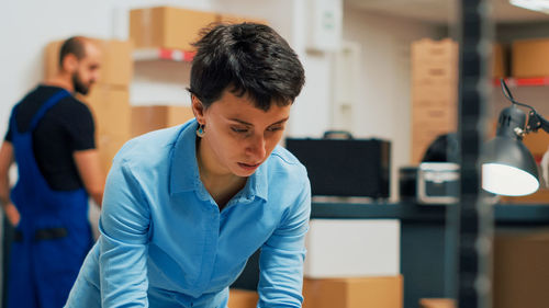 Side view of young man using mobile phone