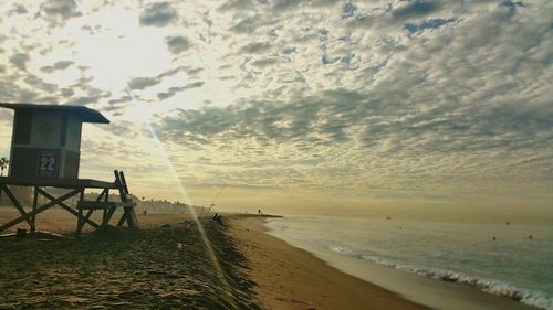 Scenic view of beach against sky during sunset