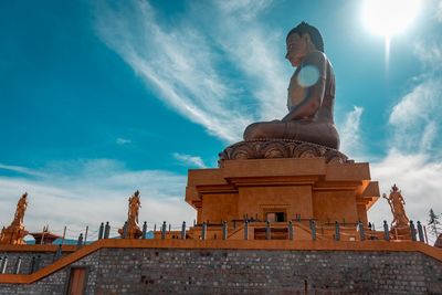 Low angle view of statues against sky