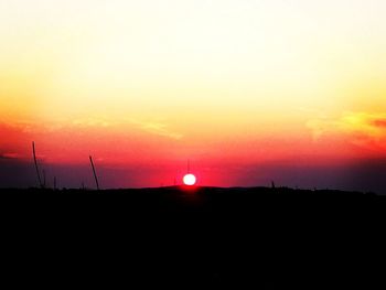 Scenic view of silhouette field against sky during sunset