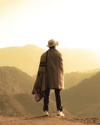 Rear view of woman standing on mountain