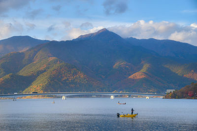 Fishing boats in kawaguchi lake with autumn mountain view. japan.