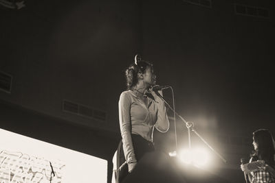 Low angle view of man standing on stage