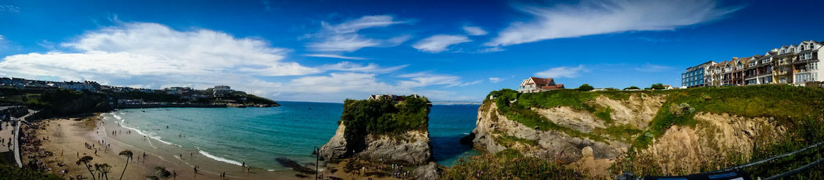 Panoramic view of beach against cloudy sky