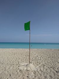 Scenic view of beach against clear blue sky