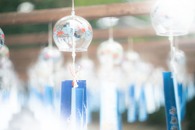 Close-up of electric lamp hanging at market stall