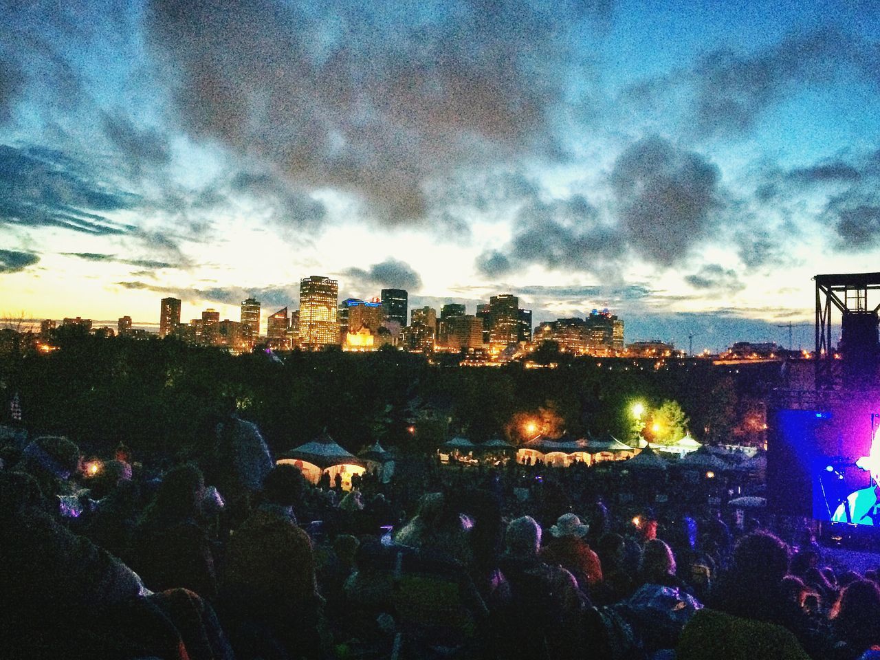 illuminated, sky, night, city, building exterior, cloud - sky, built structure, architecture, cityscape, large group of people, dusk, crowd, lifestyles, silhouette, cloudy, crowded, city life, cloud, light - natural phenomenon