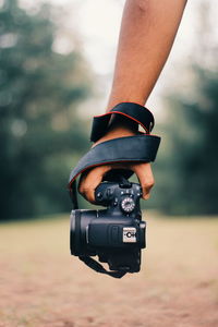 Close-up of person photographing camera