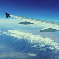 Cropped image of airplane wing over landscape