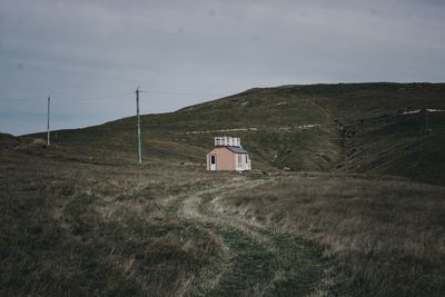 Built structure on field against sky