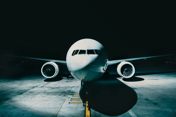 Close-up of airplane on runway at night