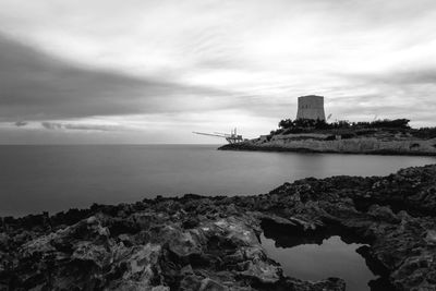 Scenic view of sea and buildings against sky