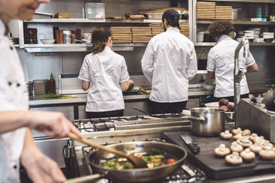 Midsection of chef preparing food in restaurant