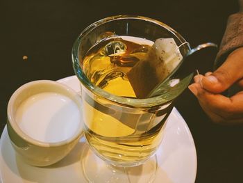 Close-up of hand holding glass of drink