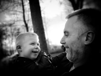 Close-up of smiling grandfather and grandchild 