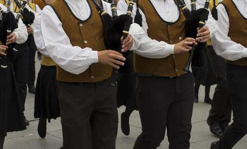 Midsection of musicians on street during festival