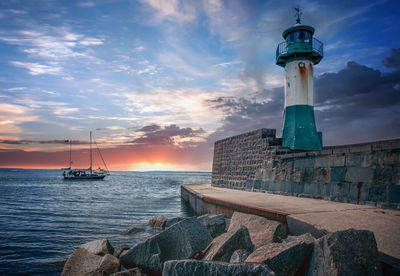 Lighthouse at seaside during sunset