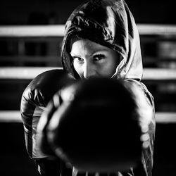 Portrait of female boxer with boxing gloves and hoodies