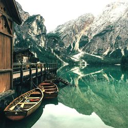 Boats in river with mountains in background