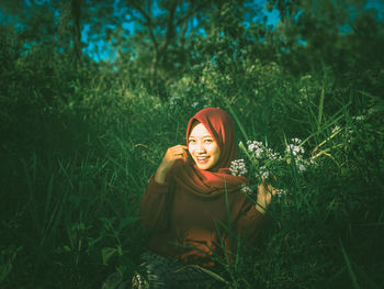 Portrait of a smiling young woman on field