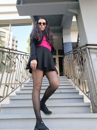 Full length portrait of woman on staircase