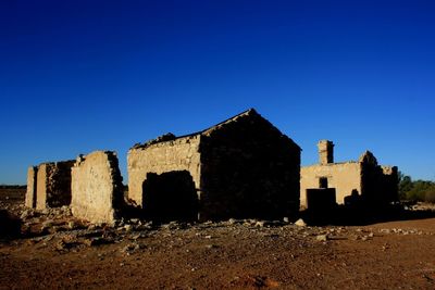 Old ruin building against blue sky