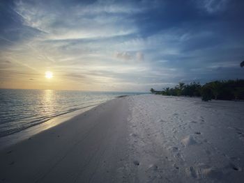 Scenic view of beach against sky during sunset