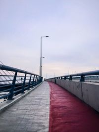 Footbridge over city against sky