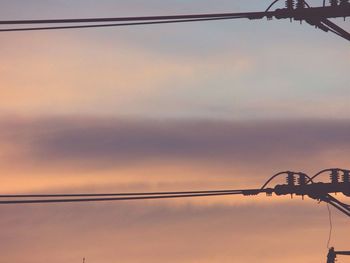 Low angle view of electricity pylon against sky