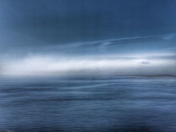 Scenic view of sea against storm clouds