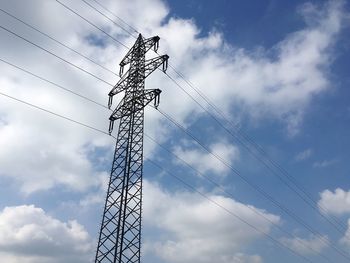 Low angle view of electricity pylon against sky