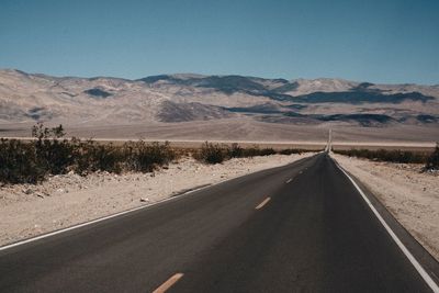 Empty road against clear sky in desert nevada california death valley national park