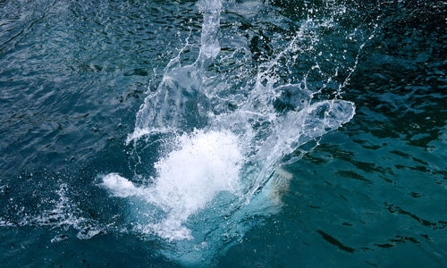 High angle view of waves splashing in sea